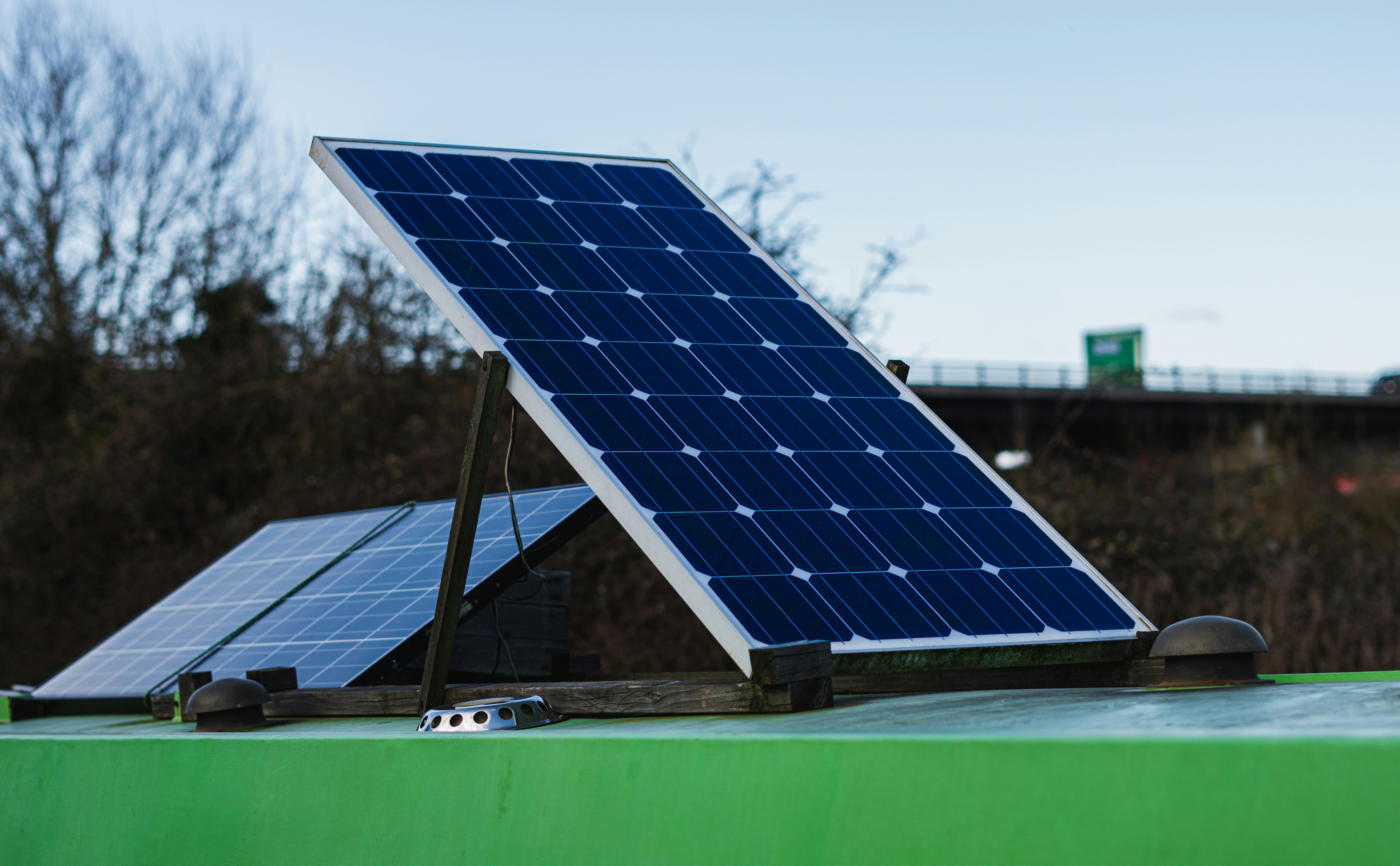 ❓ FAQ: Your Burning Solar Questions, Answered! by Gone Greenish blue and white solar panel on green metal bar during daytime