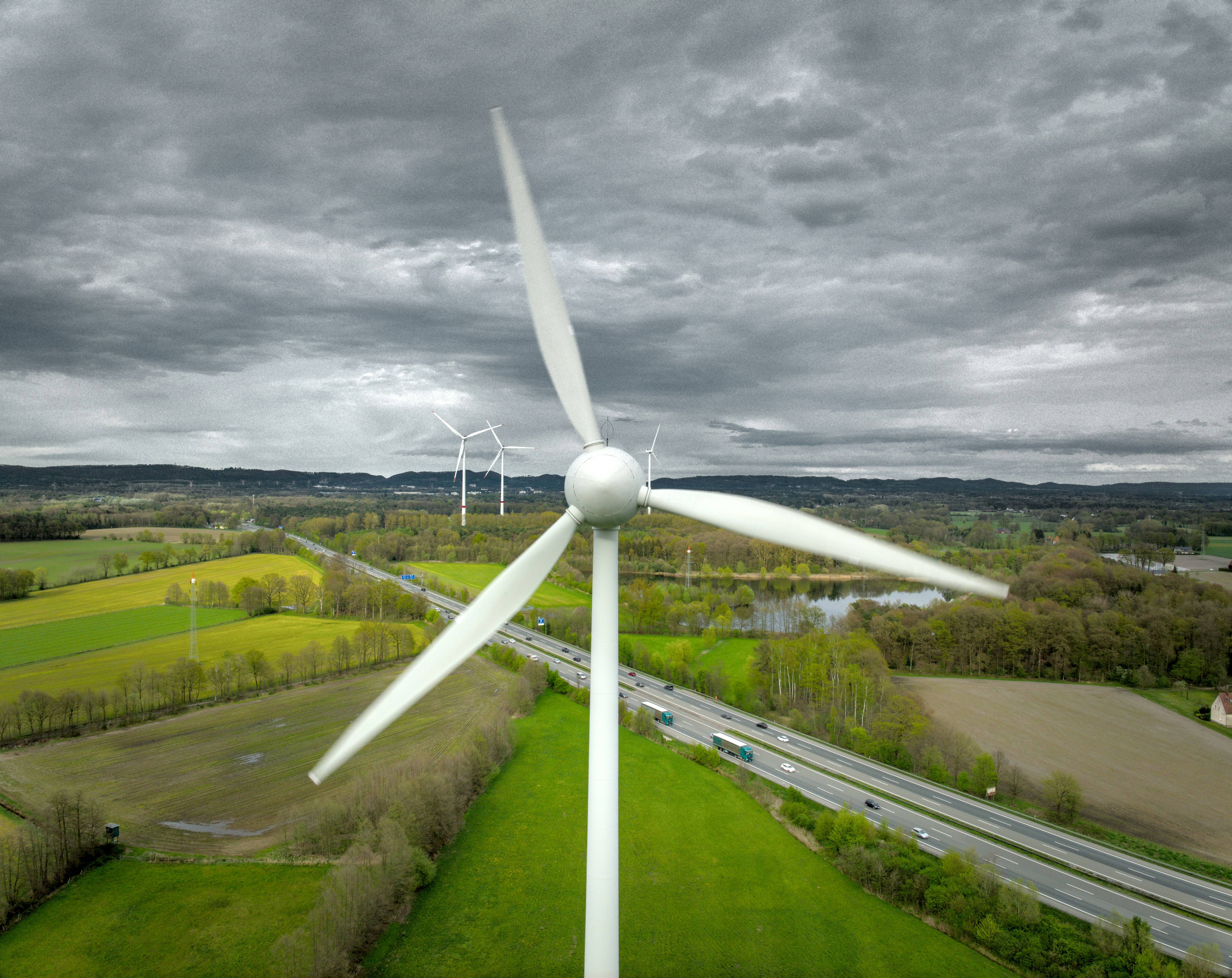 An aerial view of a wind turbine in a rural area