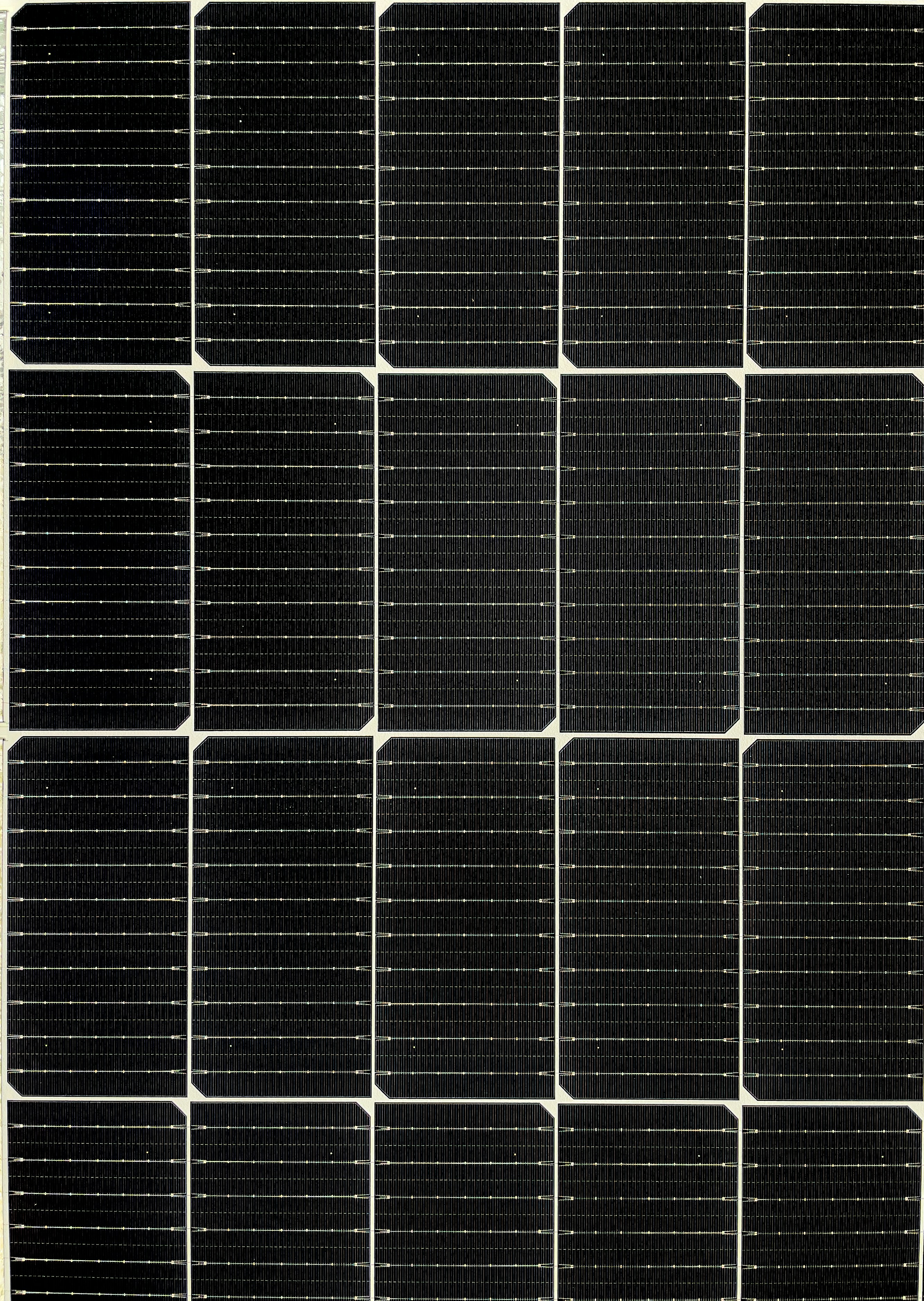 A close-up image of a solar panel showing an array of photovoltaic cells arranged in a grid pattern. The black surface of the cells features thin lines and subtle textures, indicating the intricate structure of the solar technology. The image highlights the uniformity and precision of the panel design, which is used for capturing sunlight and converting it into renewable energy. by Gone Greenish A black and white photo of a solar panel