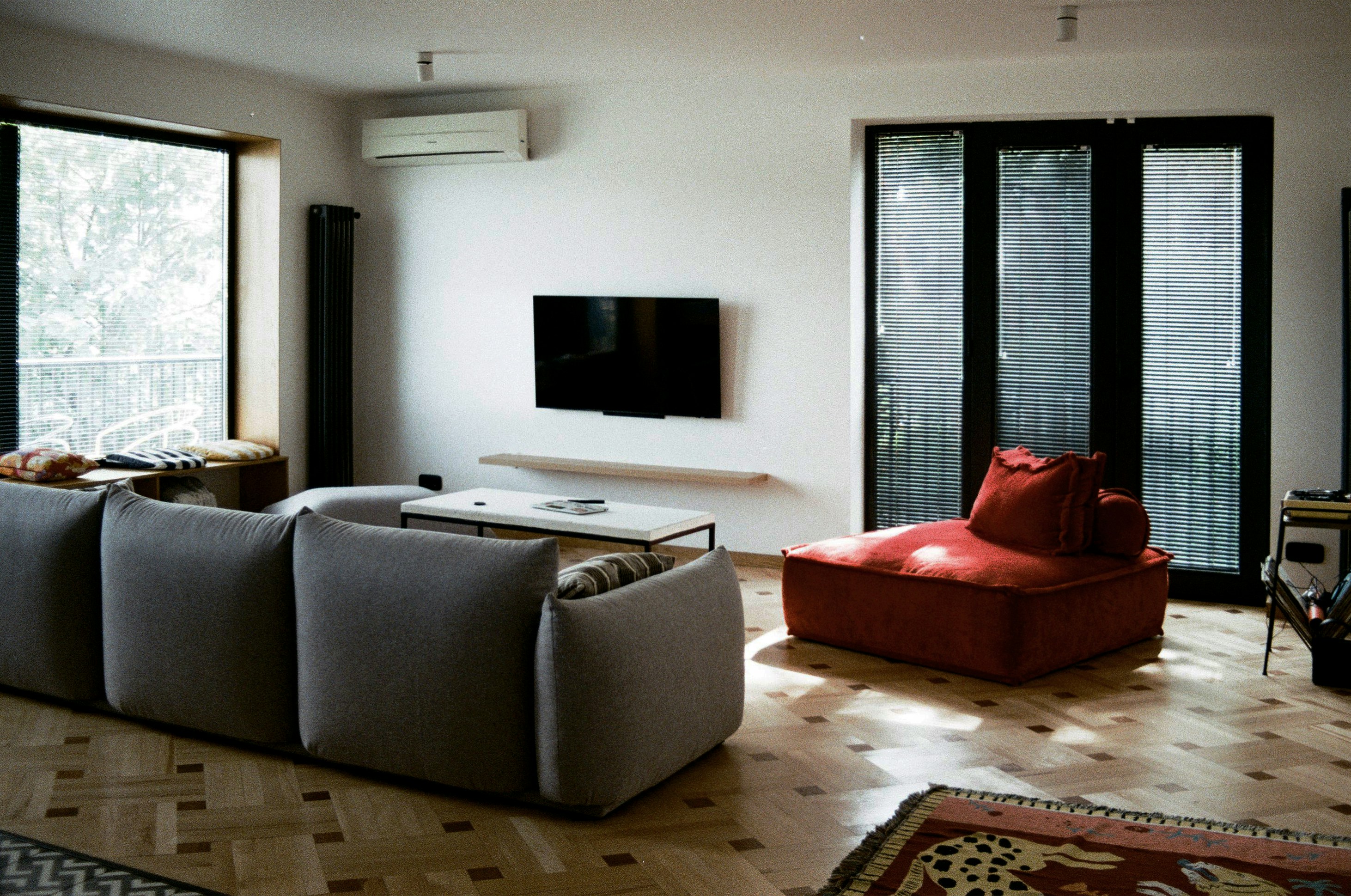 a living room filled with furniture and a flat screen tv