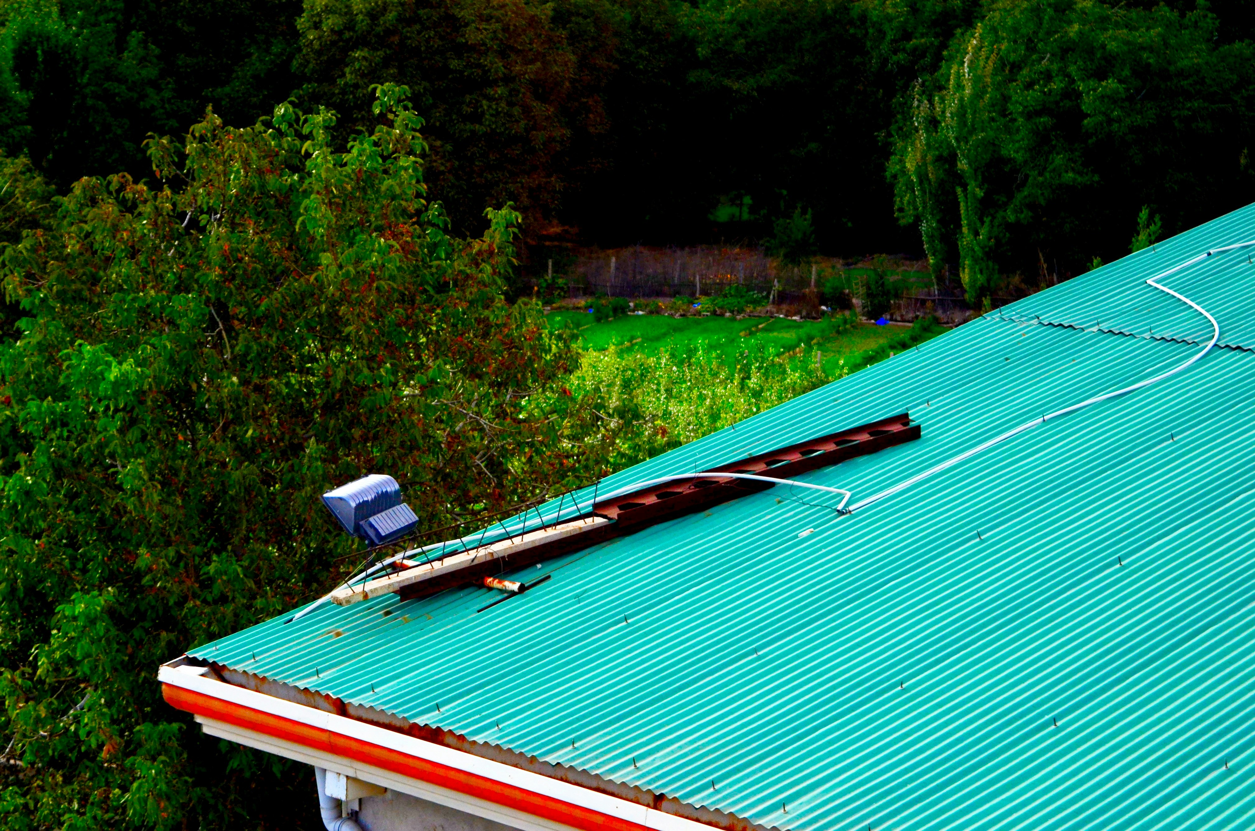 The roof of a house with a broken roof