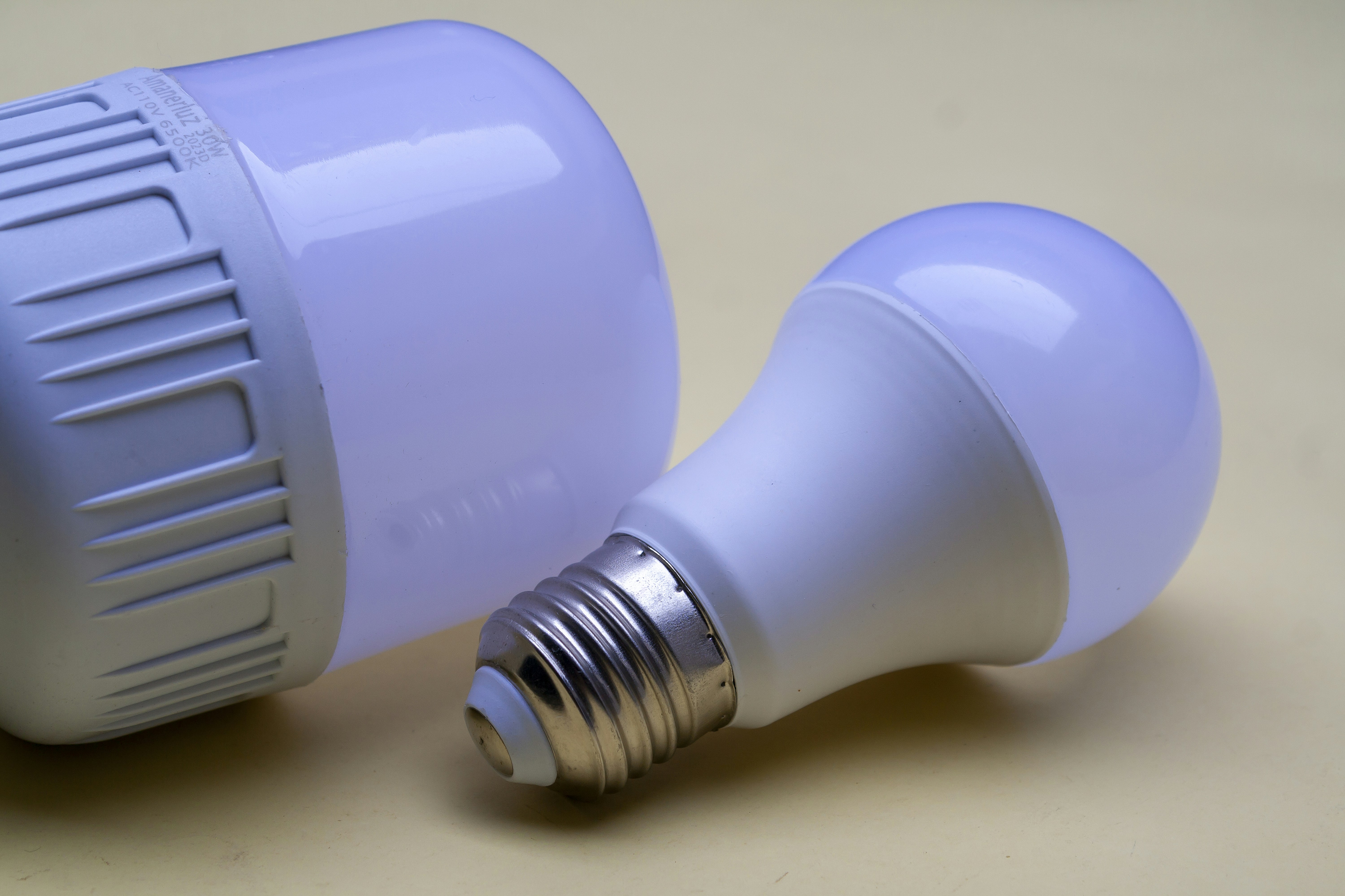 A close up of two light bulbs on a table