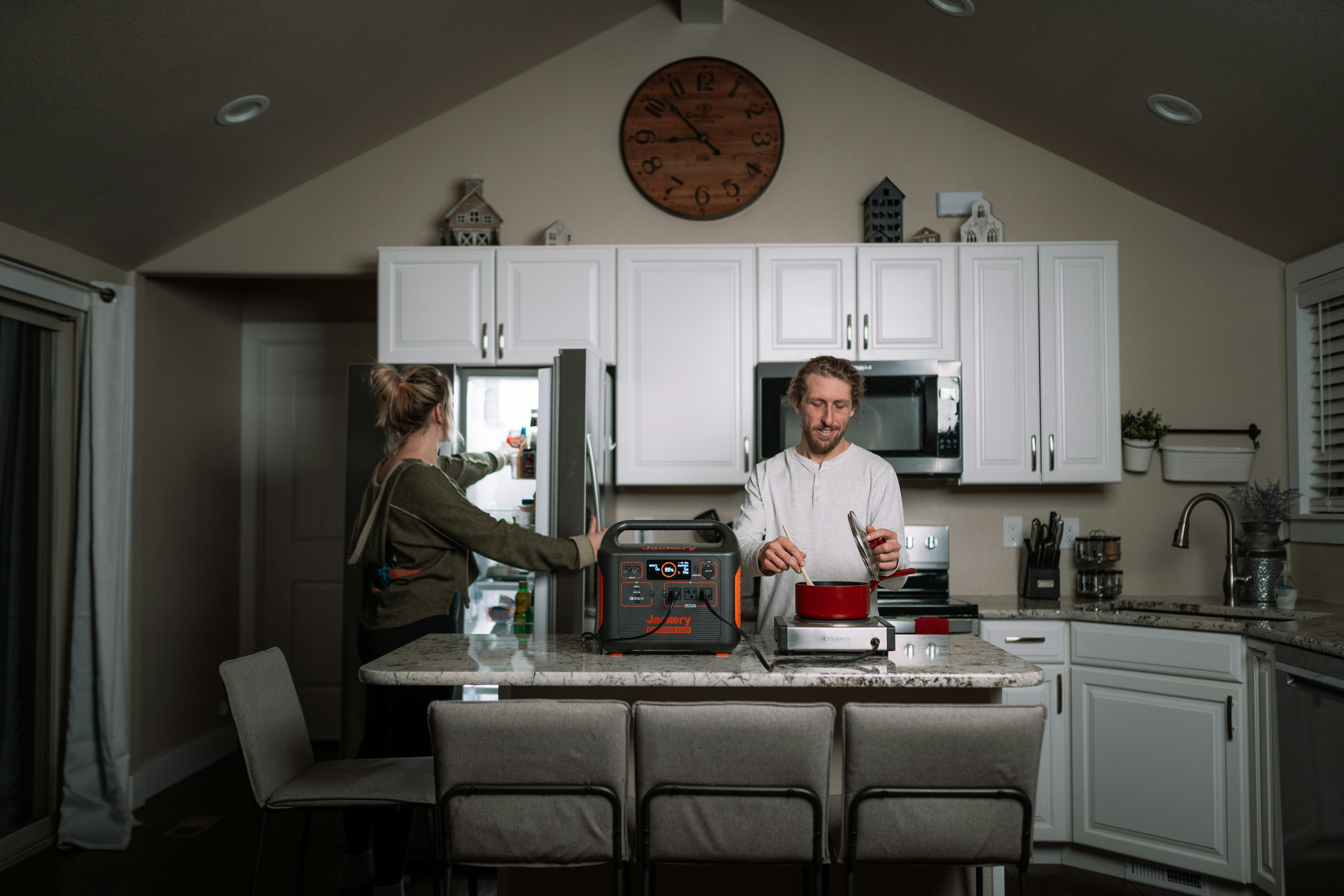 a couple of people stand in a kitchen