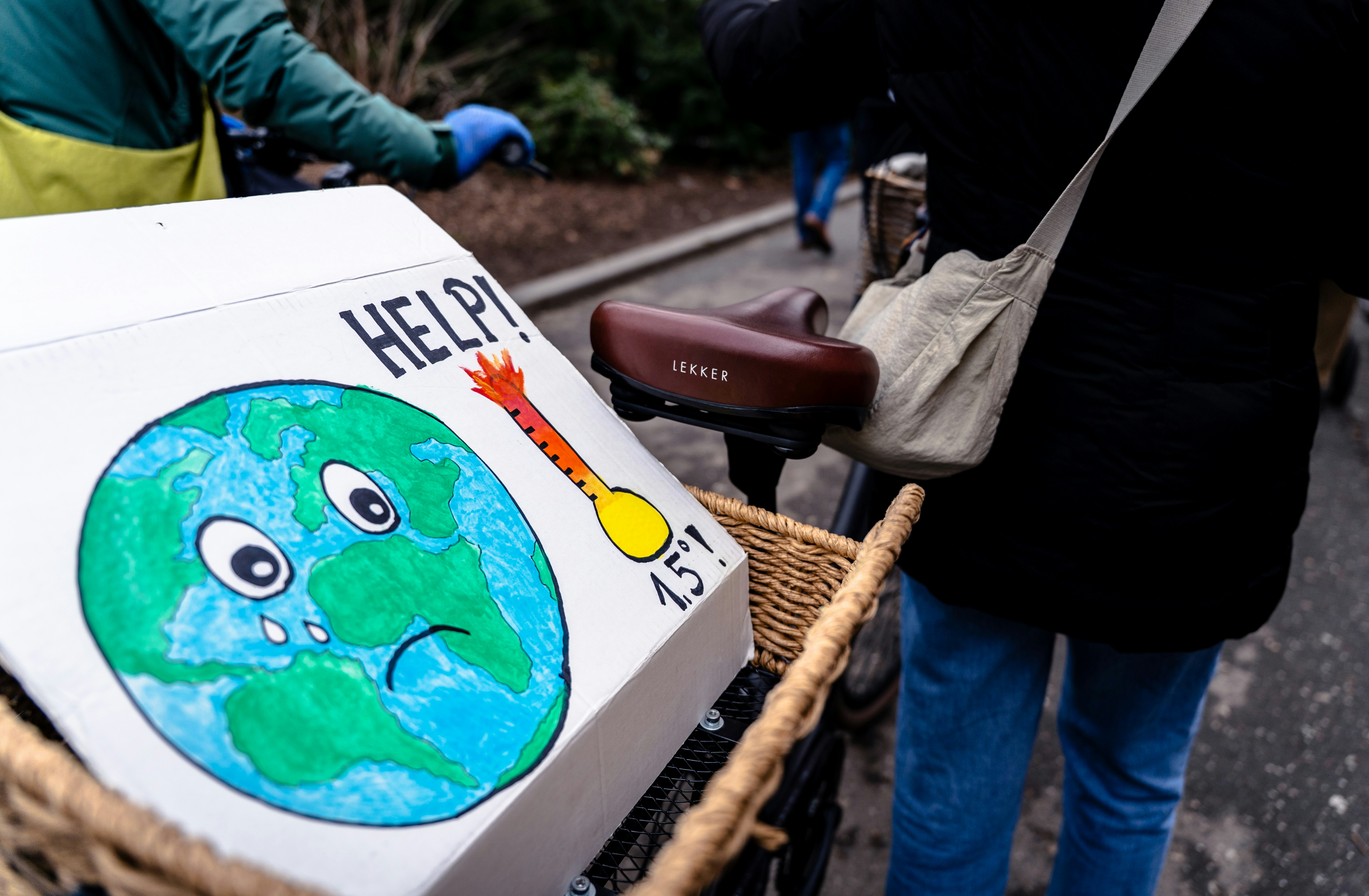 A person on a bike with a box on the back of it