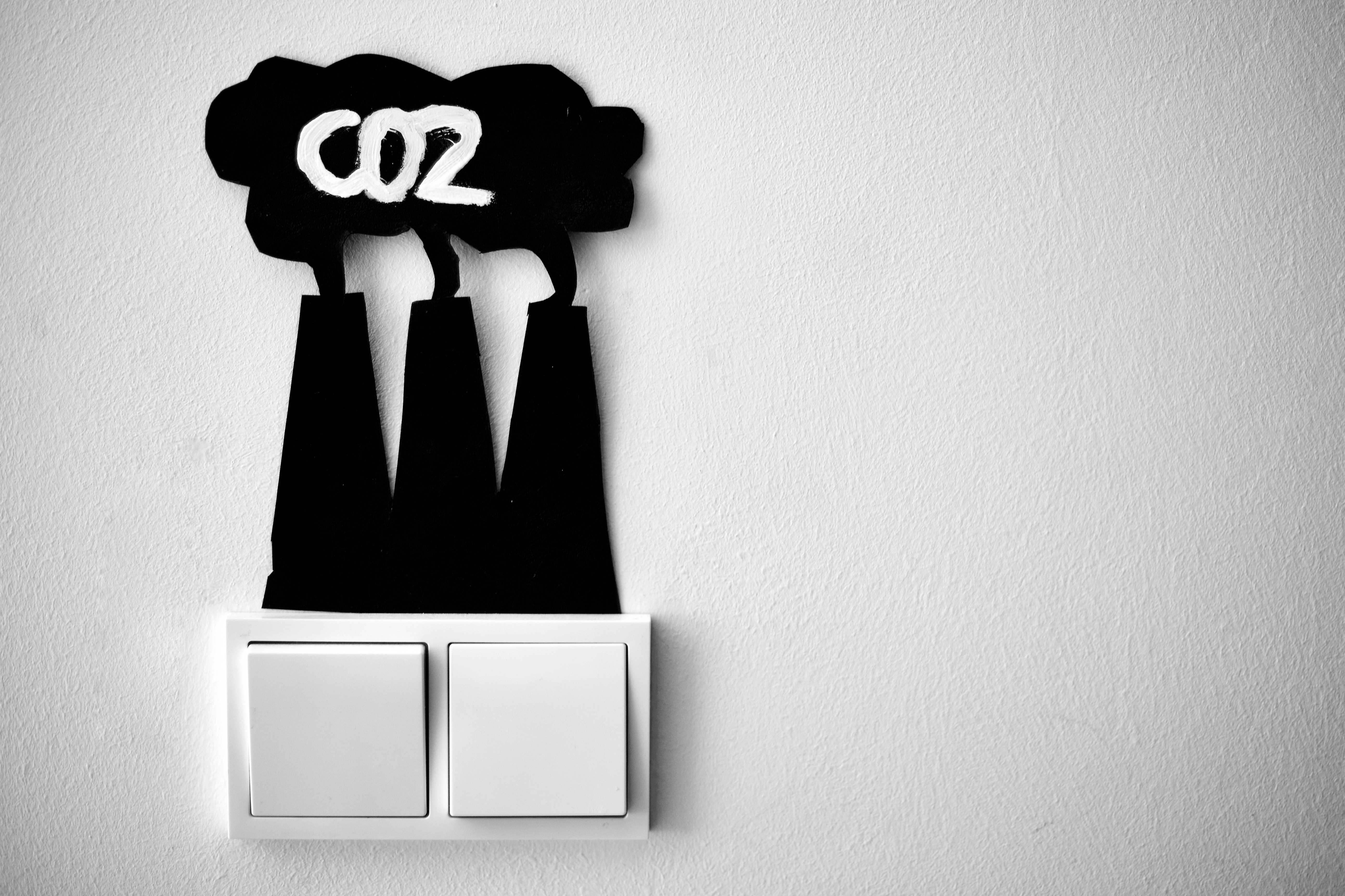 I created a little nudge for myself to remind me that every time I turn the lights on CO2 is produced. by Gone Greenish a black and white photo of a light switch