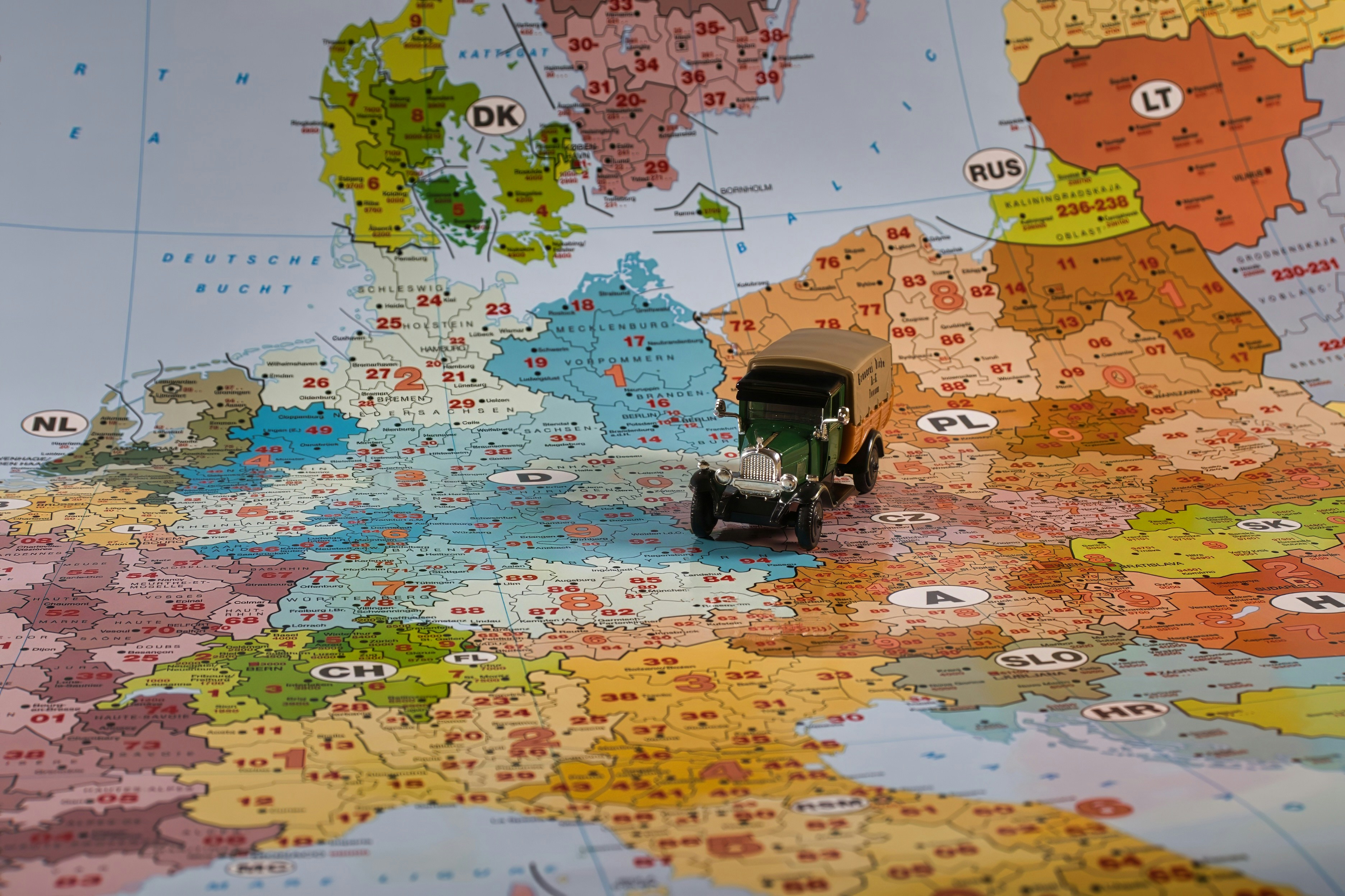 A miniature truck travels across a european map.