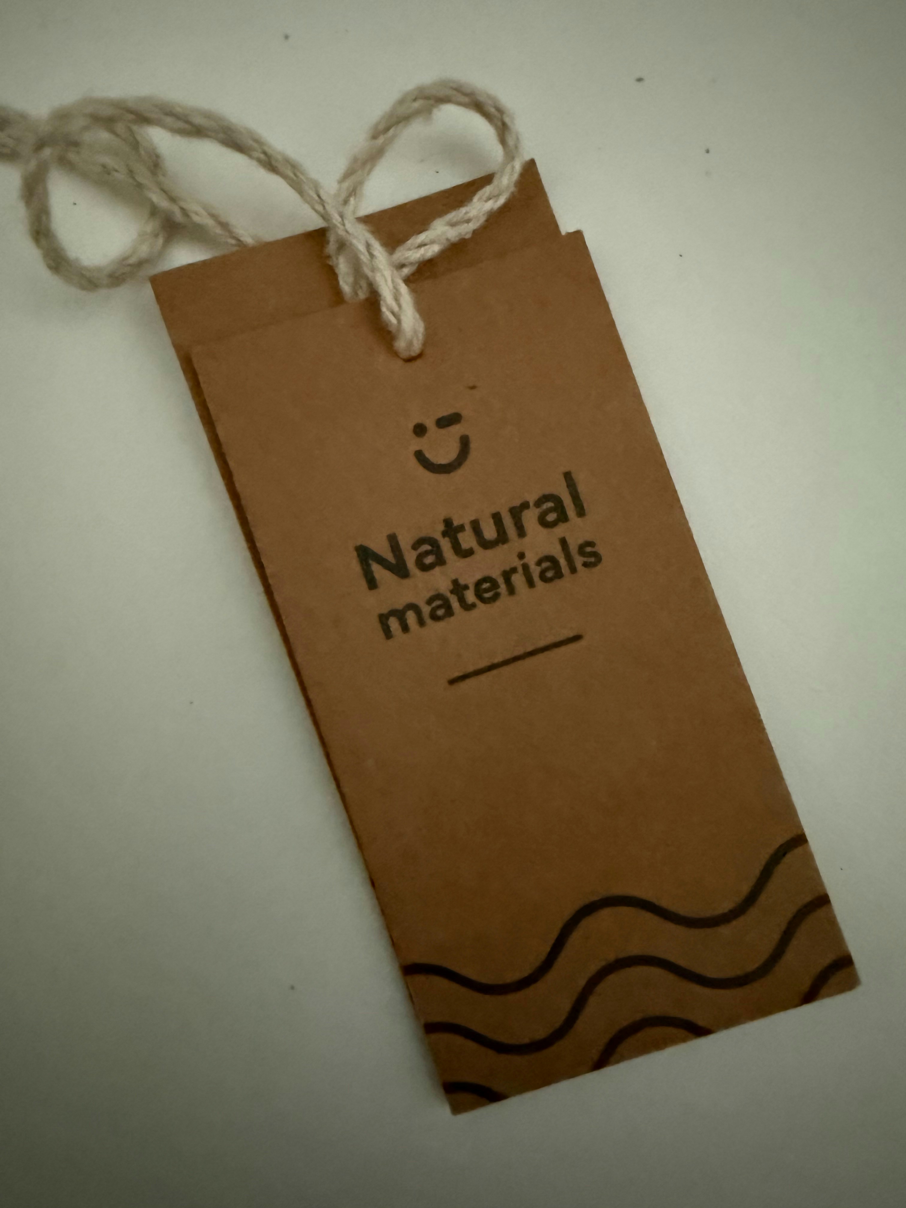 Two brown tags with rope and text.