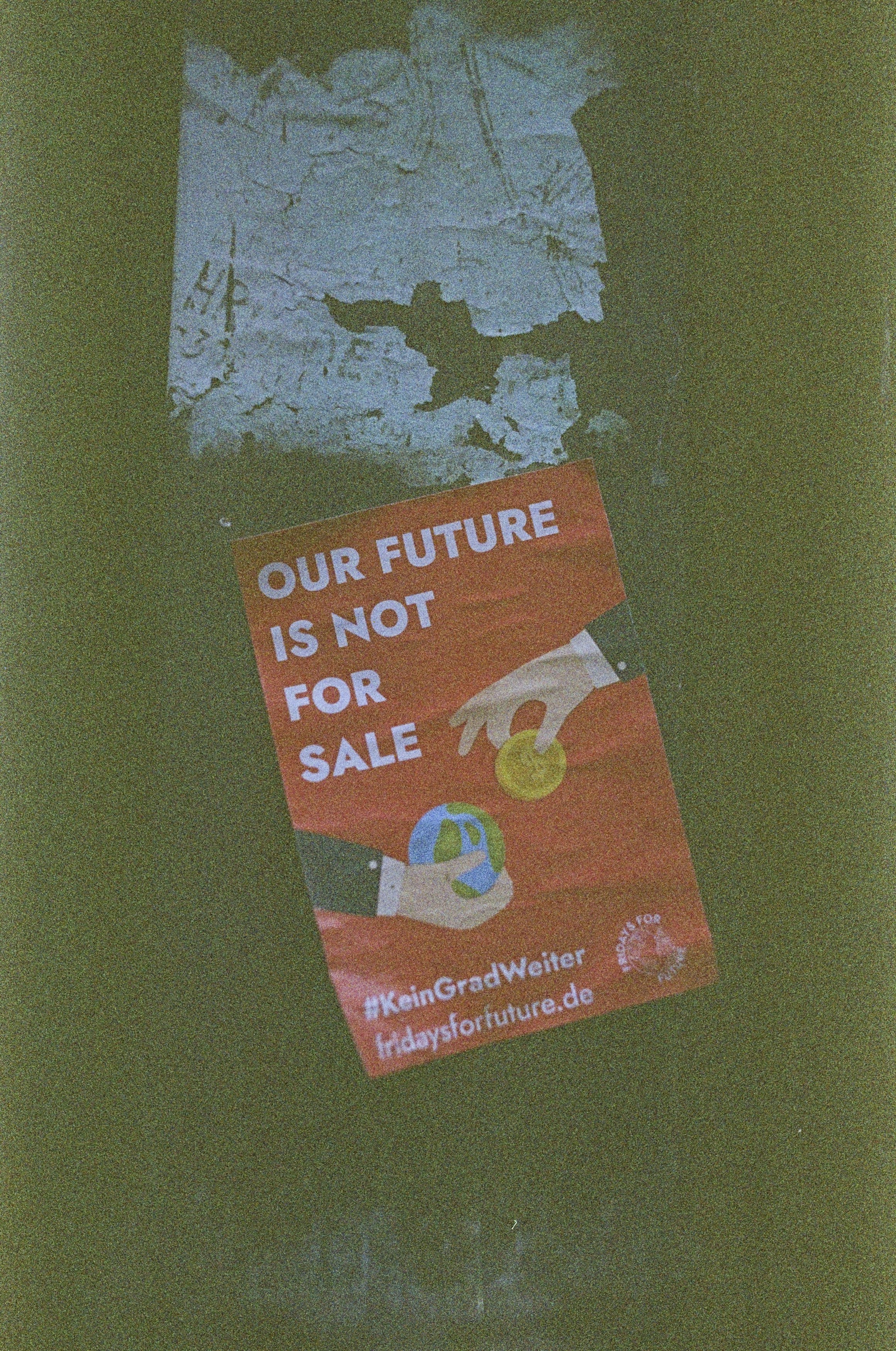 OUR FUTURE IS NOT FOR SALE. Leica R7 (1994), Elmarit-R 2.8 28mm (1977). Hi-Res analog scan by www.totallyinfocus.com – Kodak Ektapress PJ 800 (expired 2002) by Gone Greenish a sign that is on the side of a building